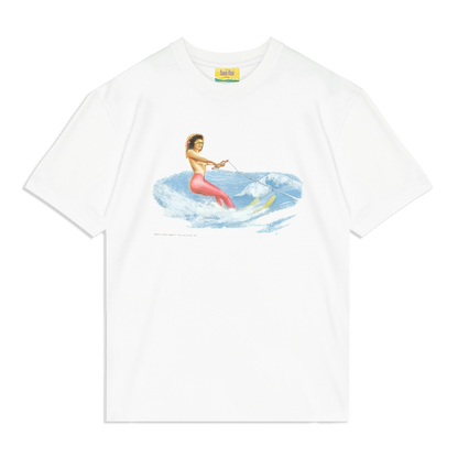 White graphic T-shirt featuring a vintage-style illustration of a woman in red pants and high heels water skiing on blue waves while holding a tow rope, with the text 'Omnia Bona Water Skiing Club '87' below the design.